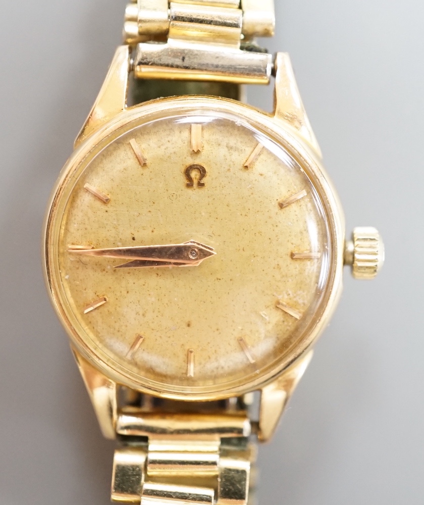 A lady's 18ct gold Omega manual wind wrist watch, on associated gilt bracelet, case diameter 23mm, with Omega guarantee pamphlet.